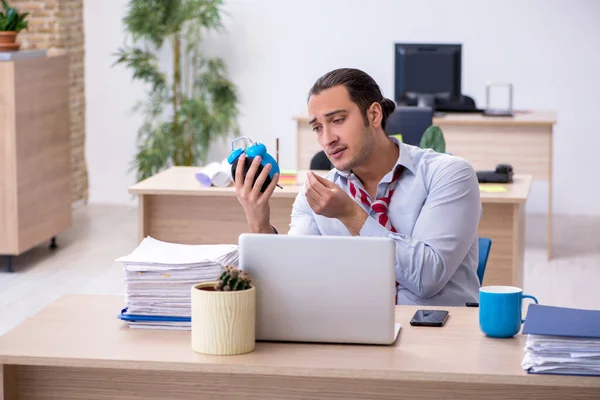 Young male employee in time management concept — Stock Photo, Image