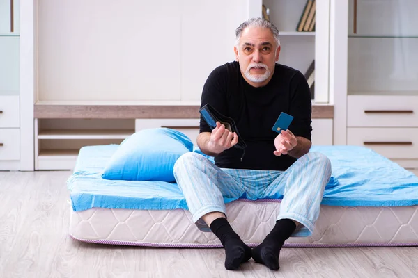 Old man running out of money in the bedroom — Stock Photo, Image