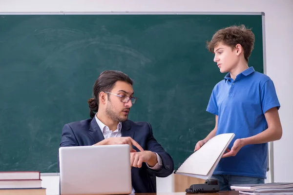 Jovem professor e estudante na sala de aula — Fotografia de Stock