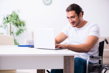 Young disabled man working from house clipart