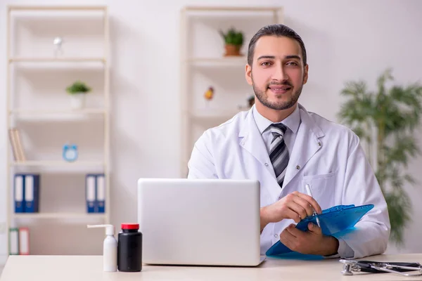 Jovem médico do sexo masculino trabalhando na clínica — Fotografia de Stock