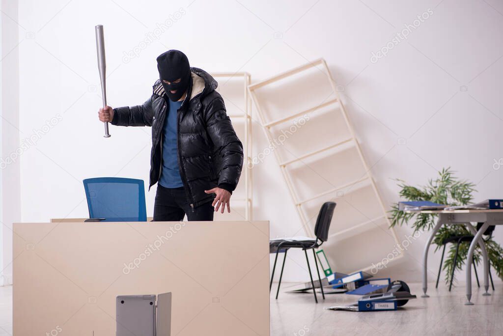 Young male burglar in the office