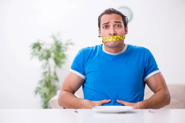 Young hungry man in dieting concept — Stock Photo, Image