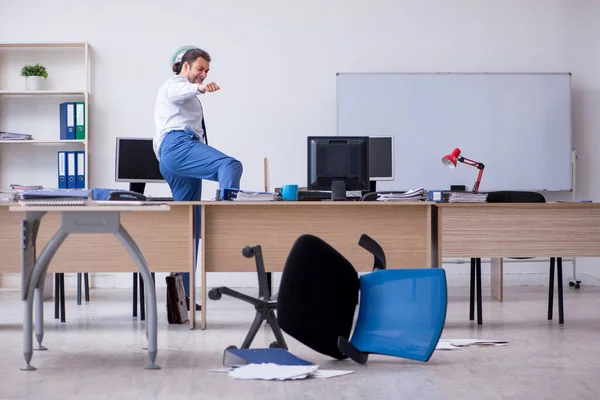 Young male employee unhappy with excessive work — Stock Photo, Image