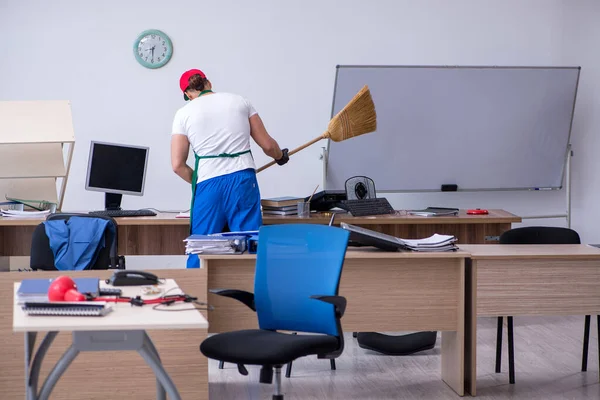 Joven contratista masculino limpiando la oficina — Foto de Stock