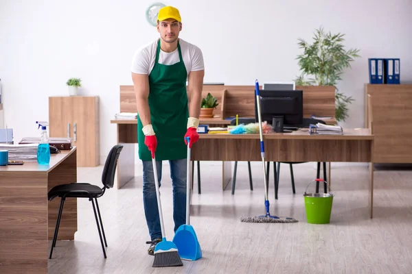 Young male contractor cleaning the office — Stock Photo, Image