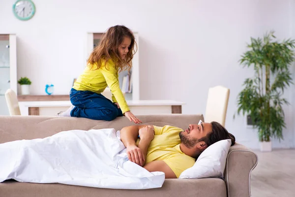 Small girl looking after her sick father — Stock Photo, Image