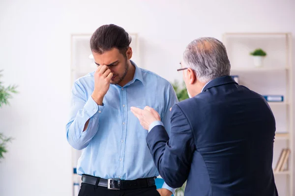 Old boss and his young assistant in the office — Stock Photo, Image