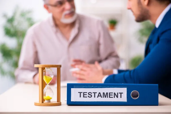 Young male lawyer and old man in testament and time management c — Stock Photo, Image
