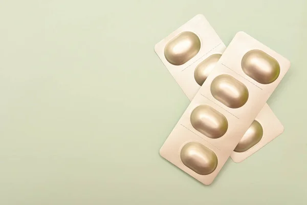 Top view of white blisters with pills on surface