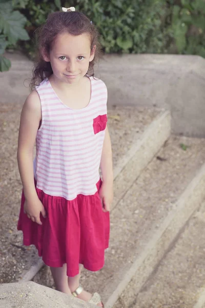 Brunette girl in pink striped dress