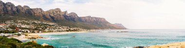 Panorama of beautiful Camps bay in Cape Town with Twelve Apostles mountain range in background clipart