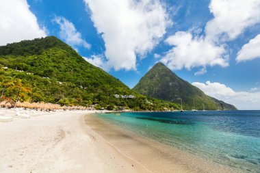 Idyllic white sand tropical beach with view to Piton mountains in Saint Lucia Caribbean clipart