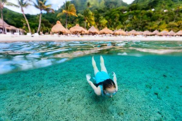 カリブ海のエキゾチックな島での夏休みを楽しんでいる熱帯の海で泳ぐ少女の水中写真を分割します — ストック写真