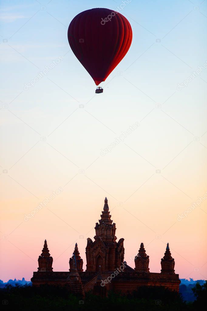 Silhouette of hot air balloon fly over ancient temple at sunrise in Bagan Myanmar