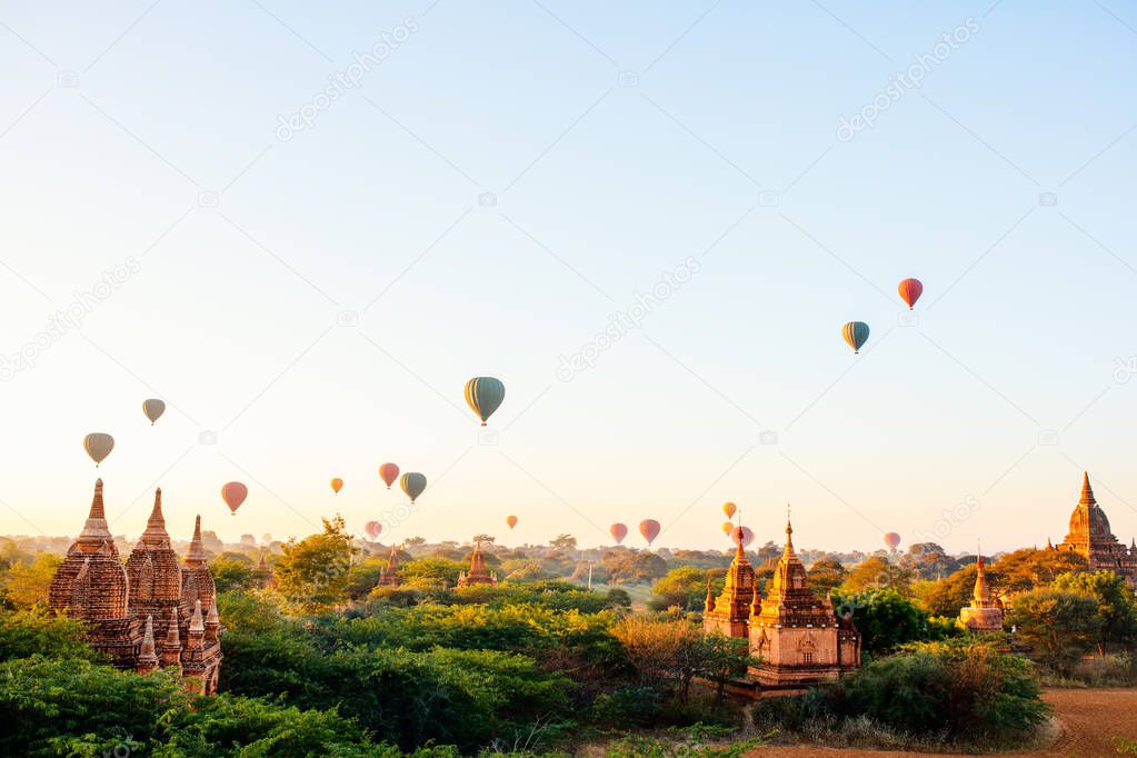 Stunning landscape view of hot air balloons fly over thousands of ancient pagodas at morning in Bagan Myanmar