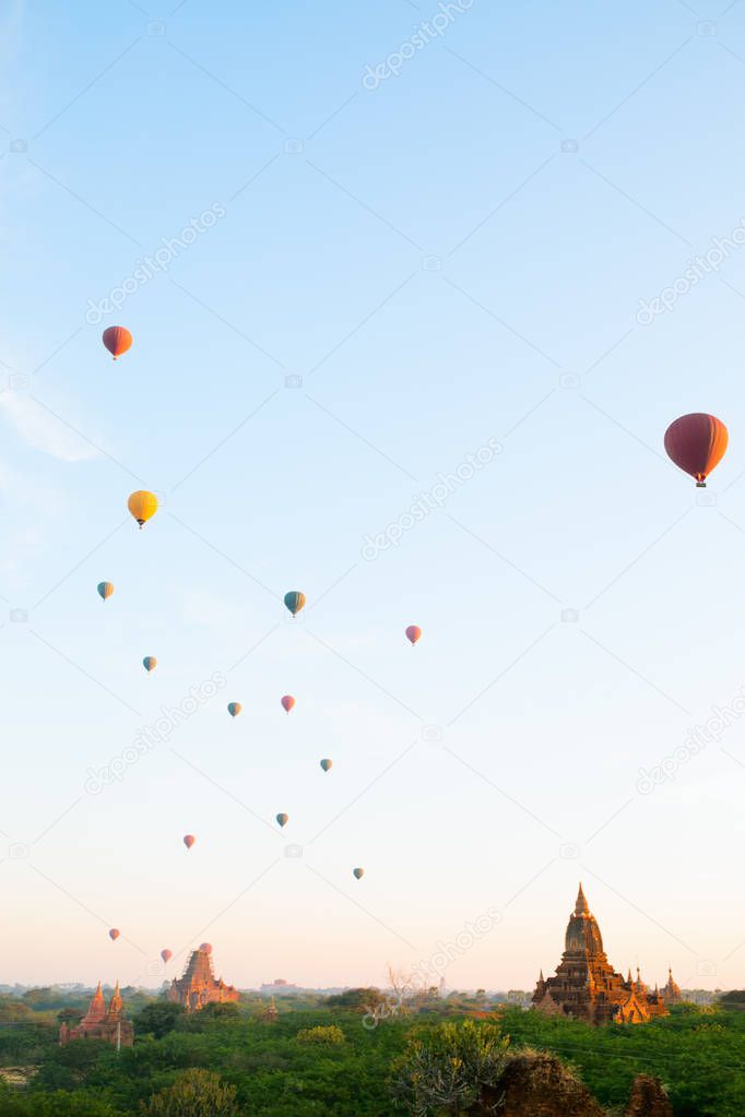 Stunning landscape view of hot air balloons fly over thousands of ancient pagodas at morning in Bagan Myanmar