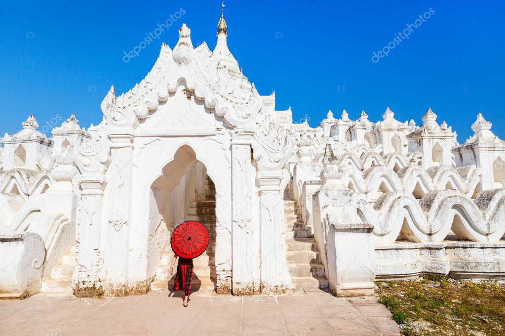 Young girl with traditional burmese umbrella at beautiful white Hsinbyume pagoda in Mingun Myanmar