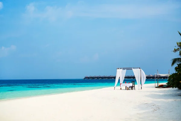 Romantic luxury dinner or lunch setting at tropical beach in Maldives