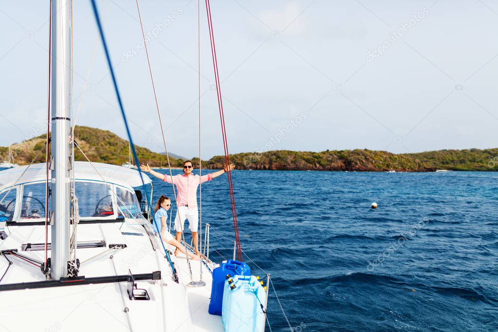Father and daughter on board of sailing yacht having summer travel adventure