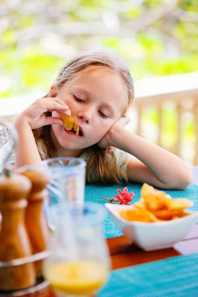 Adorable Little Girl Enjoying Eating Potato Chips Restaurant — Stock Photo, Image