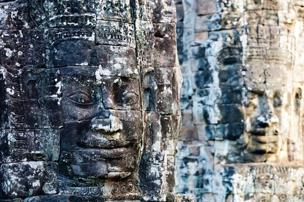 Faces of ancient Bayon temple popular tourist attraction in Angkor Thom, Siem Reap, Cambodia.