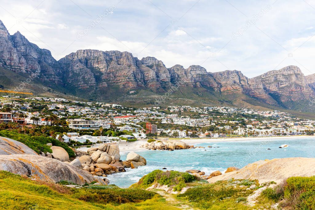 Landscape of beautiful Camps bay in Cape Town with Twelve Apostles mountain range in background