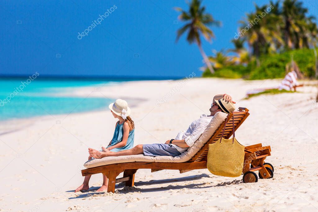 Father and his adorable little daughter at beach enjoying tropical vacation