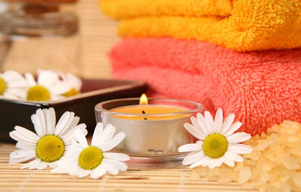 彩色毛巾 身体护理用品和燃烧的蜡烛 — 图库照片