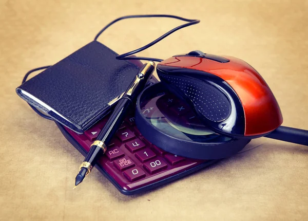 calculator, pen and computer mouse for office work