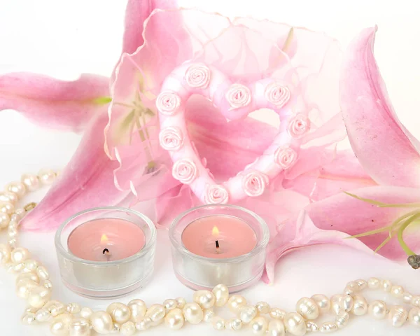 pink lily and decorative ornaments on a white background