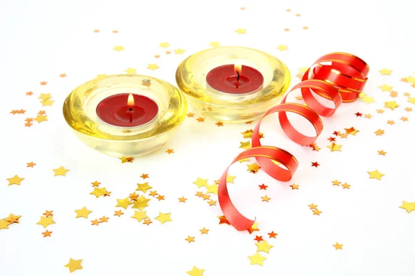 Burning candles and golden confetti — Stock Photo, Image