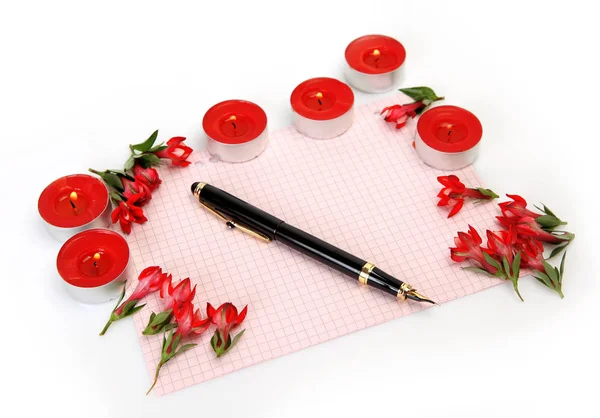 red flowers, candles and paper sheet