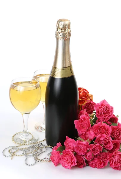 Garrafa de champanhe e rosas rosa Fotos De Bancos De Imagens