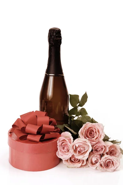 Champagne, gift and roses on a white background — Stock Photo, Image