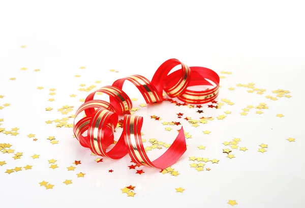 Red streamer and golden confetti — Stock Photo, Image