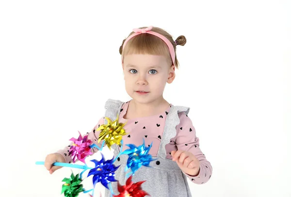 Entzückendes Kleines Mädchen Mit Buntem Spielzeug Isoliert Auf Weiß — Stockfoto