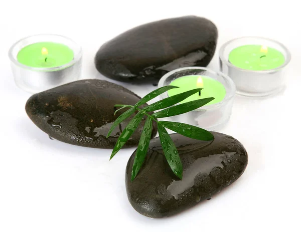 Stones, candles and green leaf — Stock Photo, Image