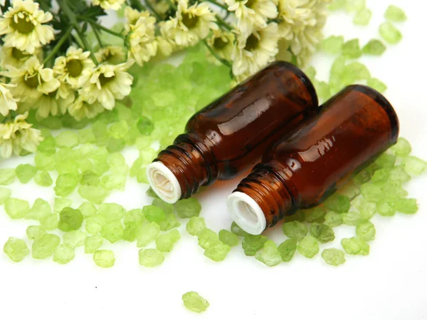 Aromatic massage oil and flowers — Stock Photo, Image