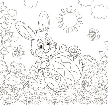 Little Easter Bunny and a colorfully decorated big egg among flowers and flittering butterflies on a lawn on a sunny spring day, black and white vector illustration in a cartoon style clipart