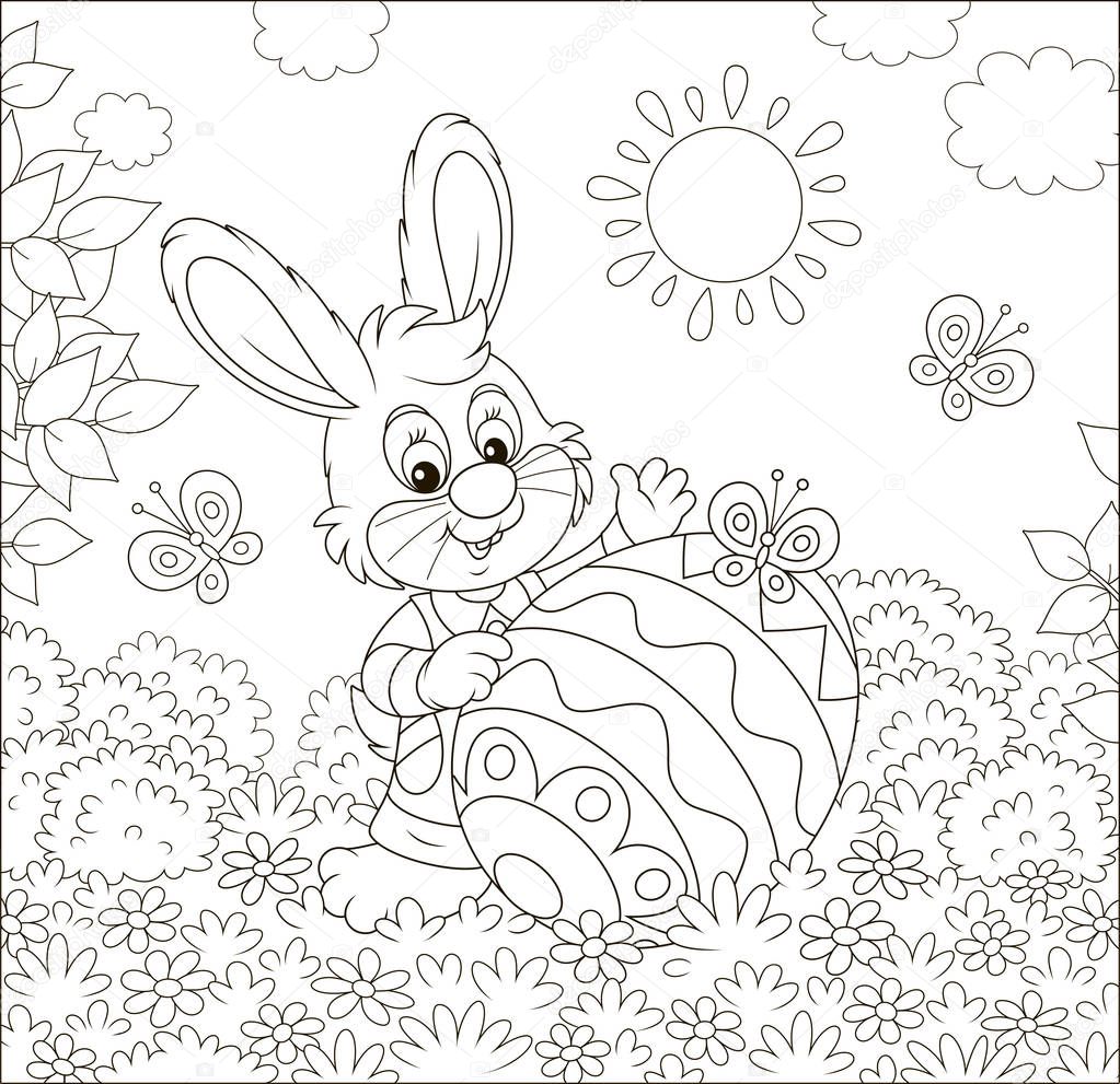 Little Easter Bunny and a colorfully decorated big egg among flowers and flittering butterflies on a lawn on a sunny spring day, black and white vector illustration in a cartoon style