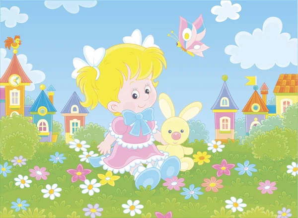 小さな町のカラフルな家の背景に緑の芝生の上に花の間に小さなおもちゃのウサギと座って美しいピンクのドレスでかわいい女の子 漫画スタイルでベクトルイラスト — ストックベクタ