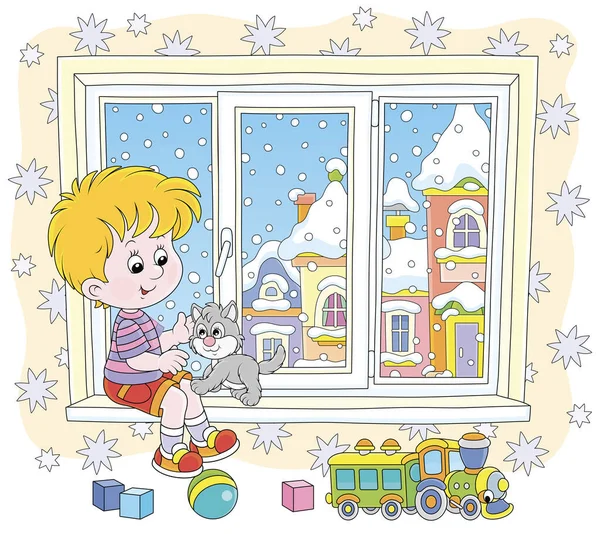 陽気な男の子遊びとともに彼の小さな灰色の子猫に窓辺の保育園で雪の冬の日 ベクトルイラストで漫画のスタイル — ストックベクタ