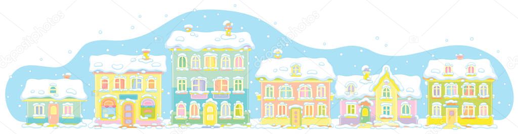 Colorful toy houses covered with snow on a cold and snowy winter day in a small town, vector cartoon illustration on a white background