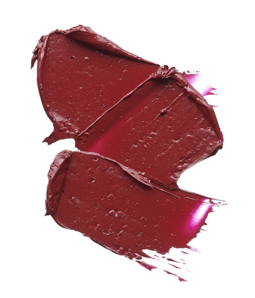 Red makeup smear of lip gloss isolated on white background. Red lipstick texture isolated on white background. Texture of broken red lipstick