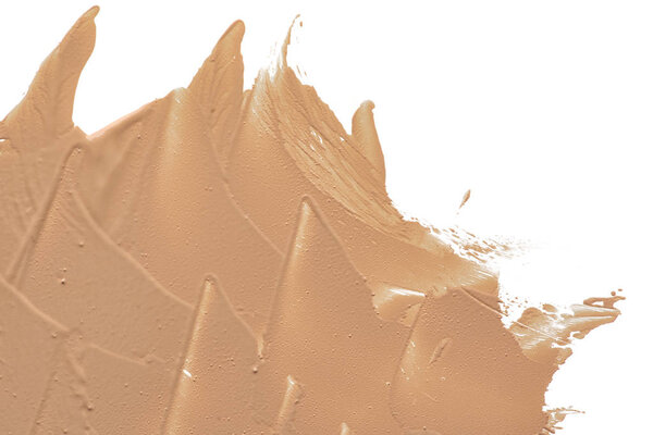 Light beige makeup smear of creamy foundation isolated on white background. Light beige creamy foundation texture isolated on white background