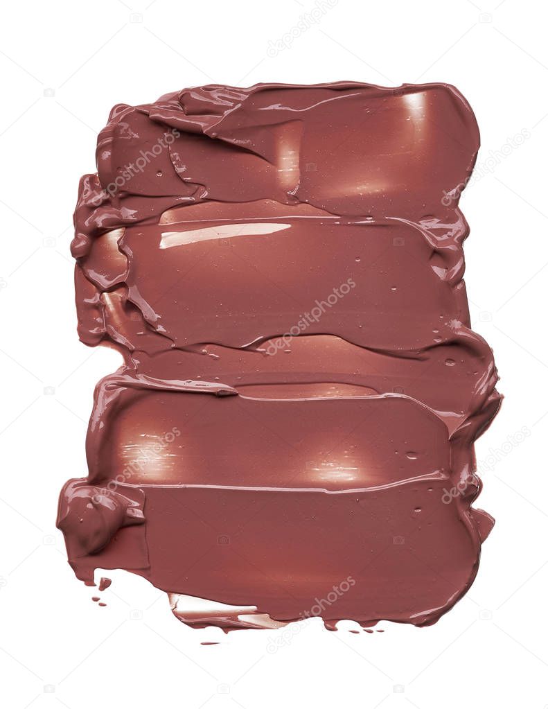 Texture of brown lipstick isolated on white background. Smear of broken brown lip gloss or creamy eye shadow isolated on a white background. Brown creamy foundation texture isolated on white