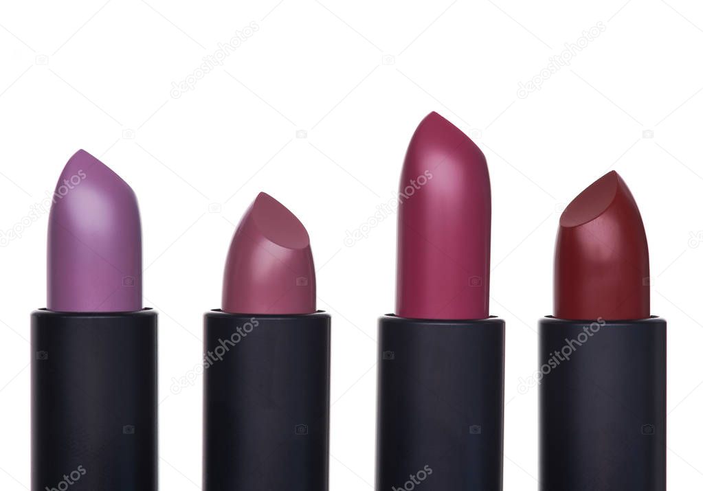 Exclusive and expensive lipsticks in a black tubes on a white background. Fashionable colors of the season