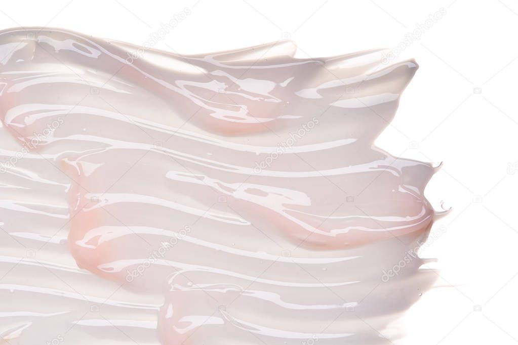 Gently pink creamy texture isolated on white background. Smear of face cream on white background