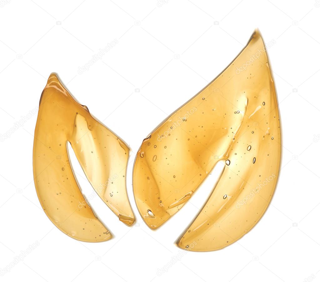 Transparent yellow smear of face cream or golden honey isolated on white background. Golden creamy honet texture on white background